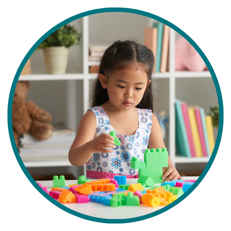 A child building with coloured blocks during a play-based session
